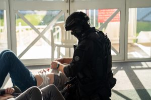 A firearms officer provides first aid to a 'casualty'.